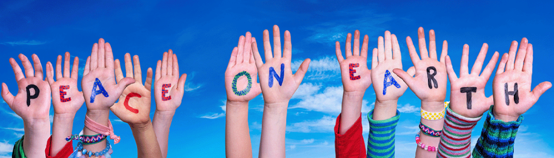 child hands spelling peace on earth